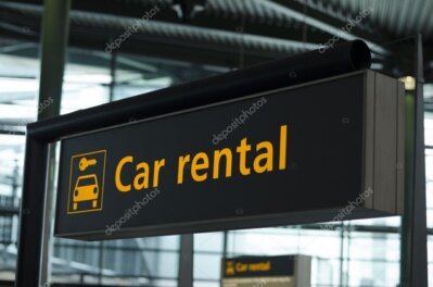 Traveler picking up a rental car at an airport terminal desk